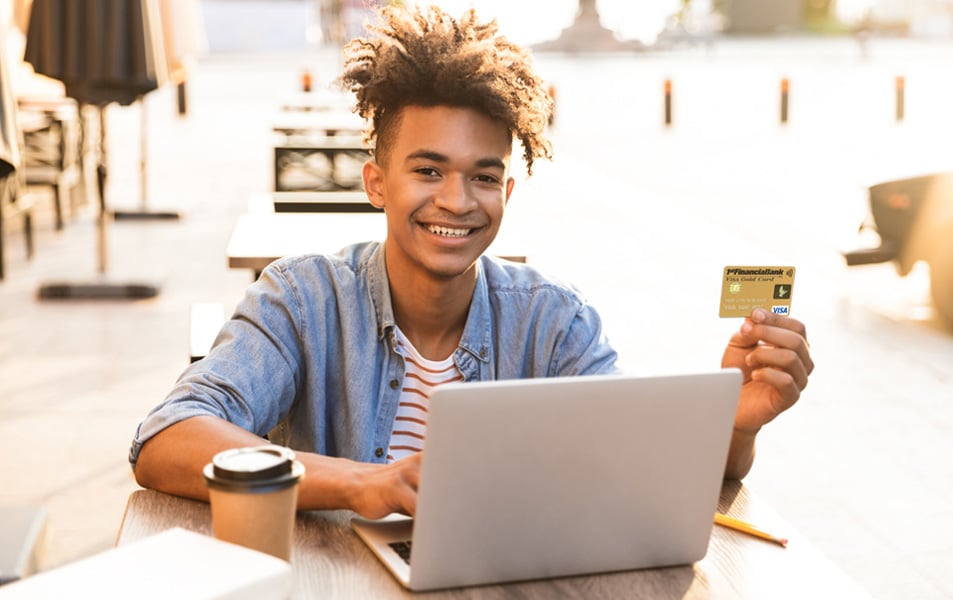 Male student holding credit card