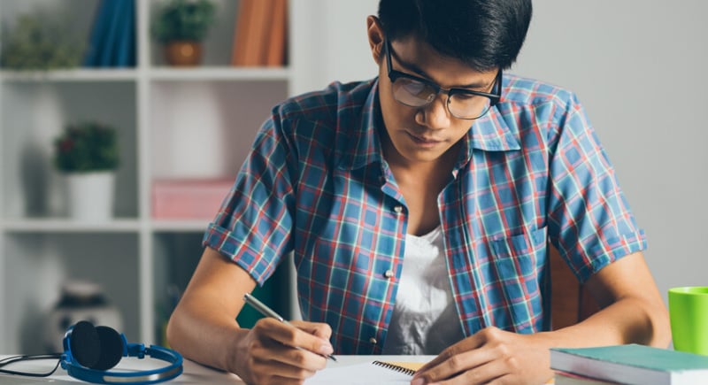 Male studying in his dorm