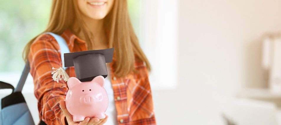 female student holding a piggybank